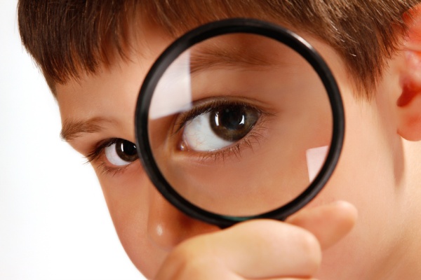 green eyes through magnifying glass